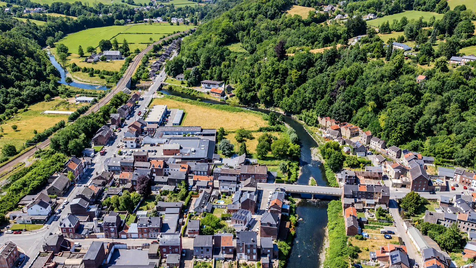 Vue aérienne de Trooz traversée par la Vesdre, avec le pont et les quartiers voisins